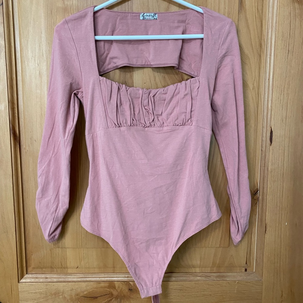 Never worn! Free people pink open back body suit